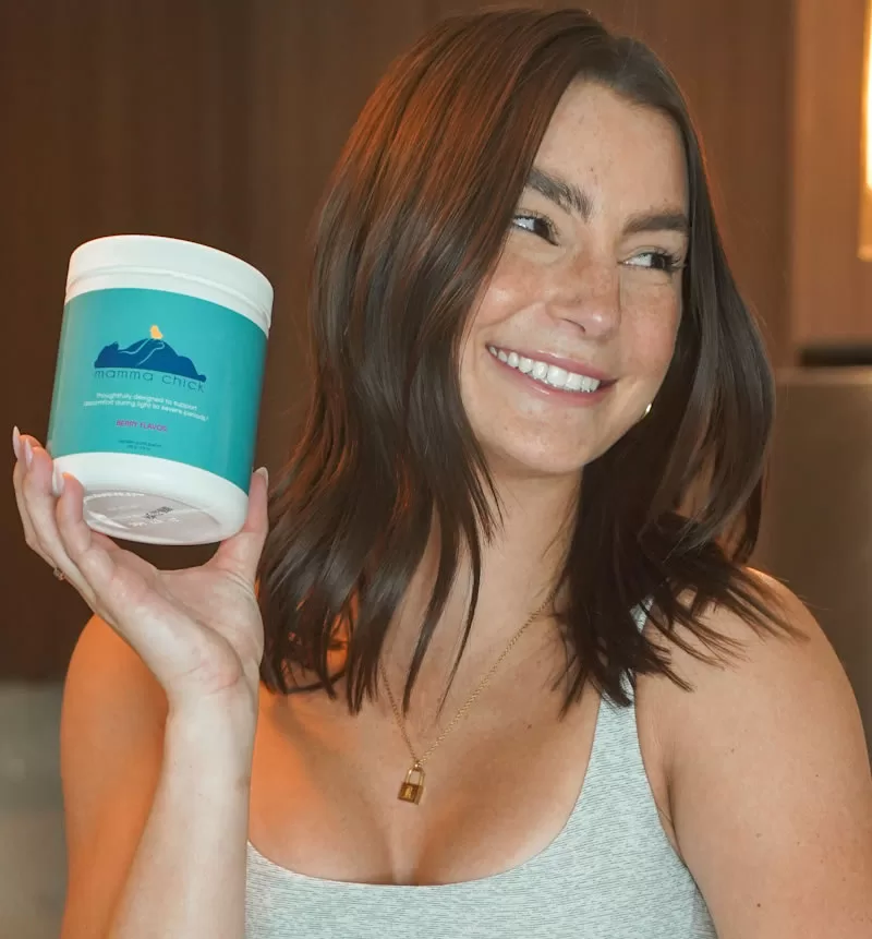 Woman holding PMS supplement bottle